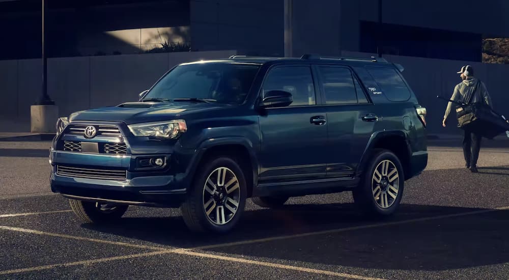 A blue 2023 Toyota 4Runner TRD Sport is shown parked on a parking space.
