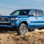 A popular vehicle for car sales, a blue 2016 Toyota Tacoma, is shown parked off-road.