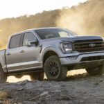 A silver 2021 Ford F-150 Tremor is shown from the front at an angle after leaving a dealer that has a Ford F-150 for sale.