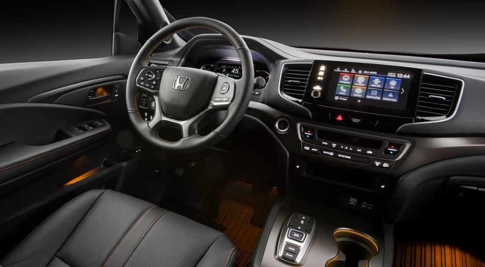 The black interior is shown in a 2023 Honda Passport TrailSport.