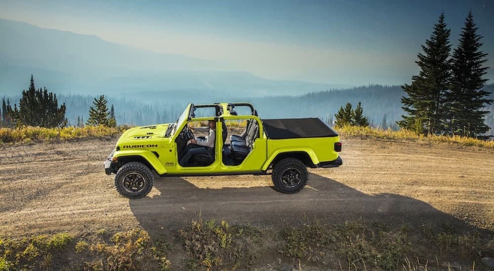 A green 2023 Jeep Gladiator Rubicon is shown driving off-road.