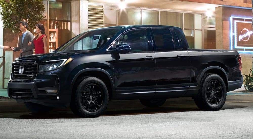 A black 2023 Honda Ridgeline is shown from the side.