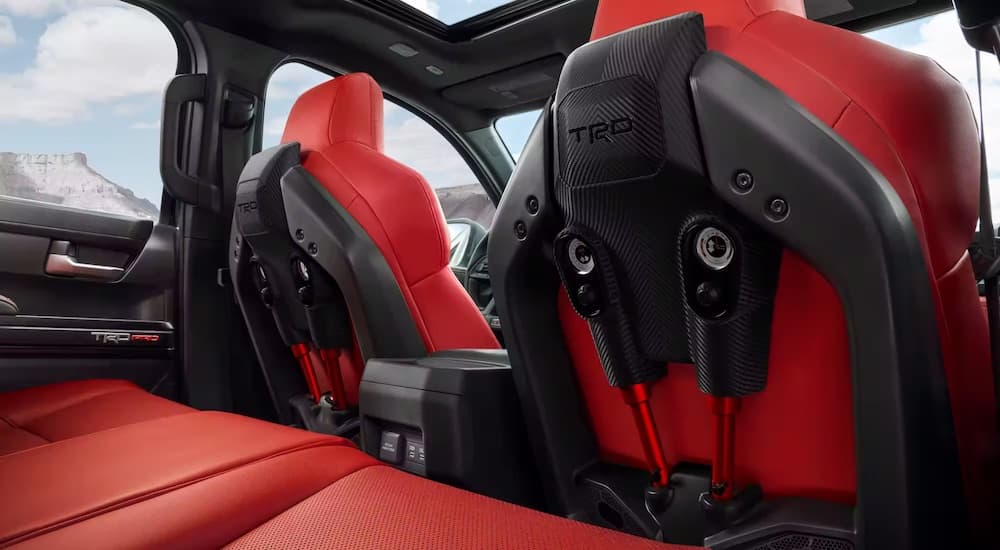 The red seats in a 2024 Toyota Tacoma TRD Pro are shown from behind.