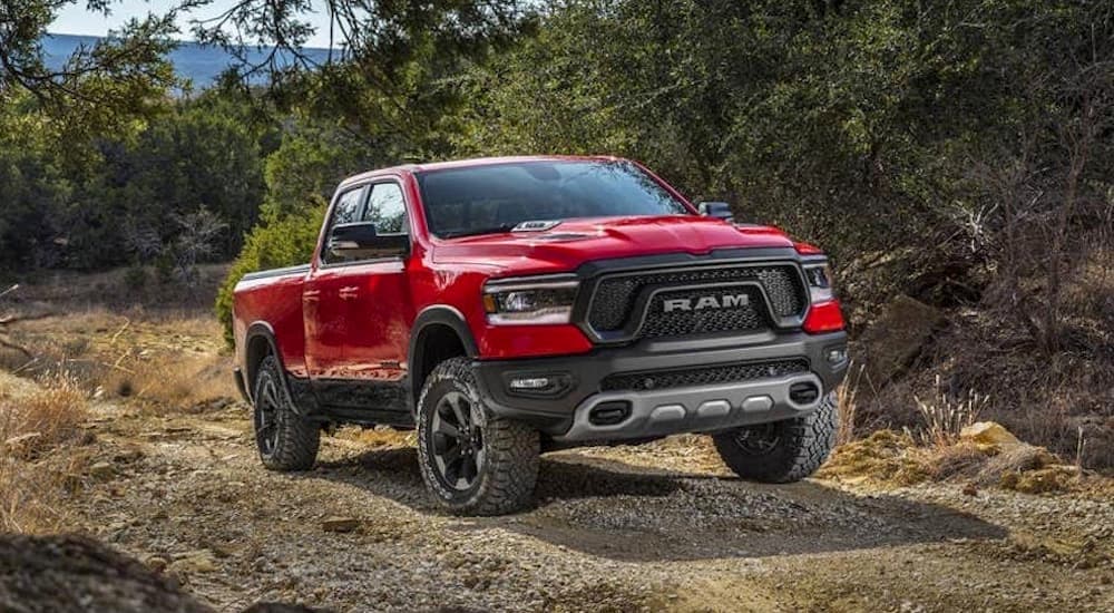 A red 2019 Ram 1500 is shown driving off-road.