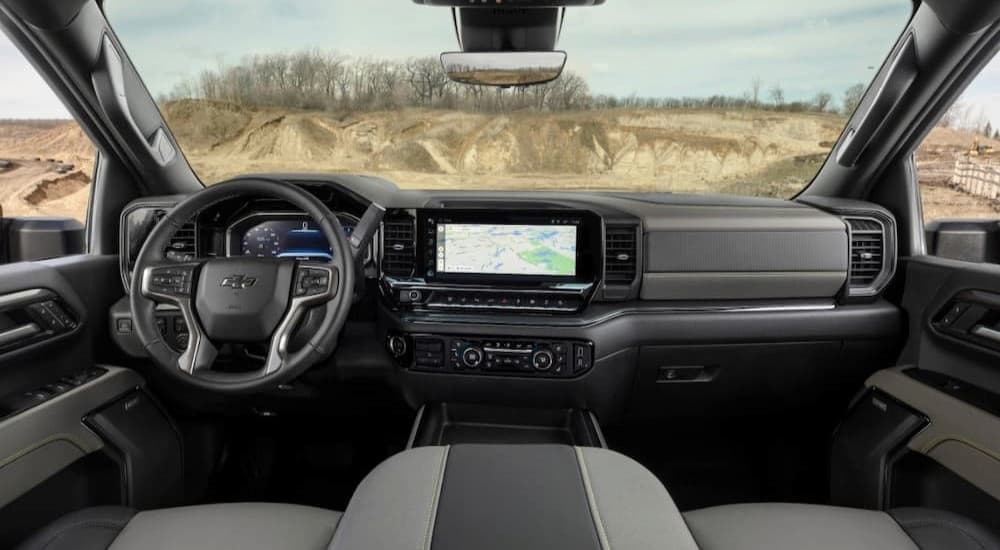The black and gray interior and dash in a 2024 Chevy Silverado 1500 is shown.
