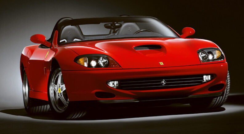A studio shot of a red 2001 Ferrari 550 Barchetta Pininfarina is shown.