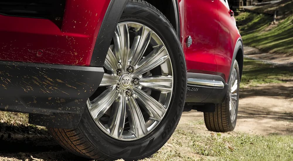 A close-up of the front wheel on a red 2023 Ford Explorer ST is shown.