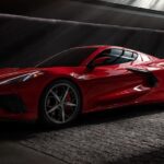 One of many popular used cars for sale, a 2020 Chevy Corvette, is shown parked in a dark room.