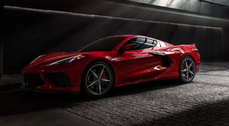 One of many popular used cars for sale, a 2020 Chevy Corvette, is shown parked in a dark room.