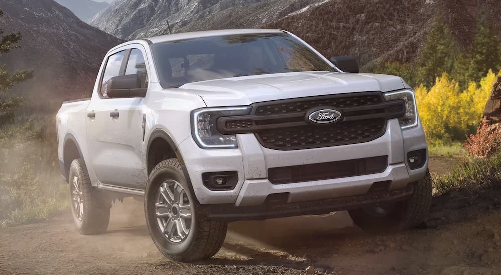A white 2024 Ford Ranger is shown driving.