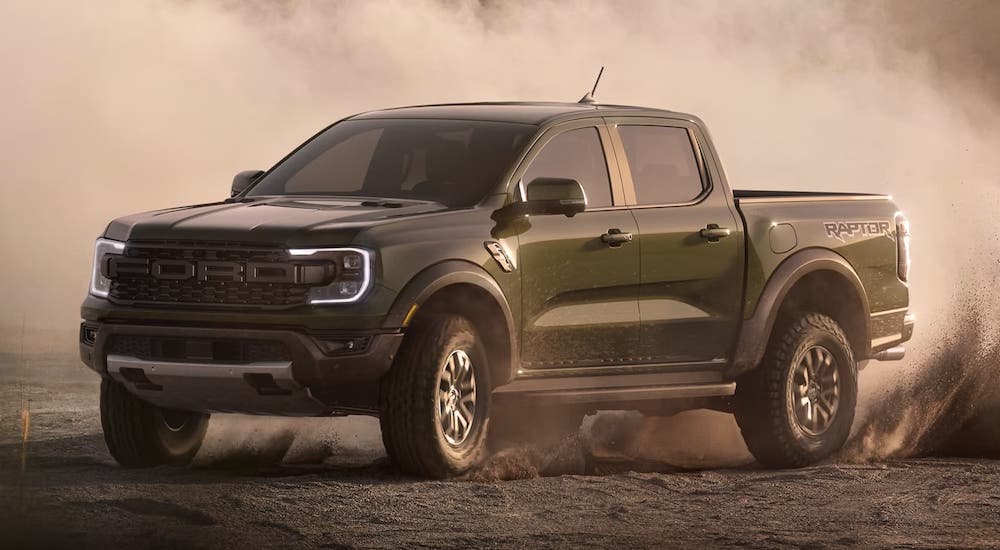 A green 2024 Ford Ranger is shown driving off-road in a desert.