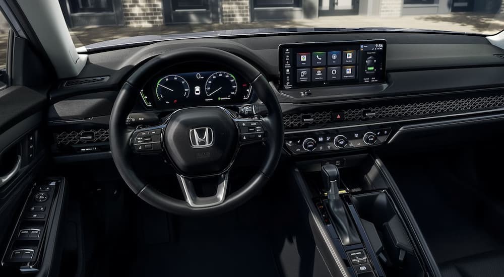 The black interior and dash of a 2024 Honda Accord for sale is shown.