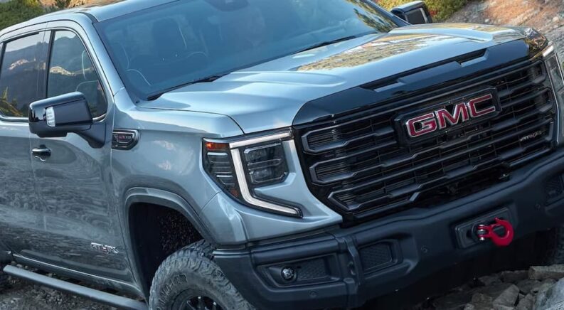 A close up of a silver 2024 GMC Sierra 2500HD AT4 AEV leaving a GMC dealer near you is shown.