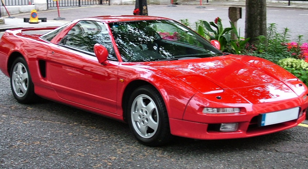 A red 1993 Honda NSX is shown parked near a curb.