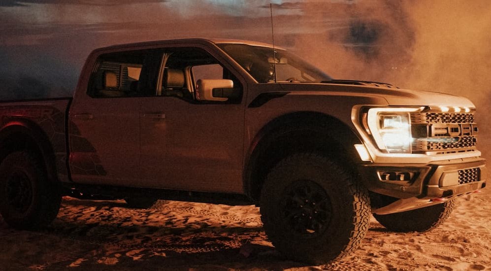 The Car of the Nation, a silver 2023 Ford F-150 Raptor R, is shown parked on sand.