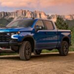 A blue 2024 Chevy Silverado 1500 ZR2 is shown parked off-road after competing in a 2024 Chevy Silverado 1500 vs 2024 Ford F-150 comparison.