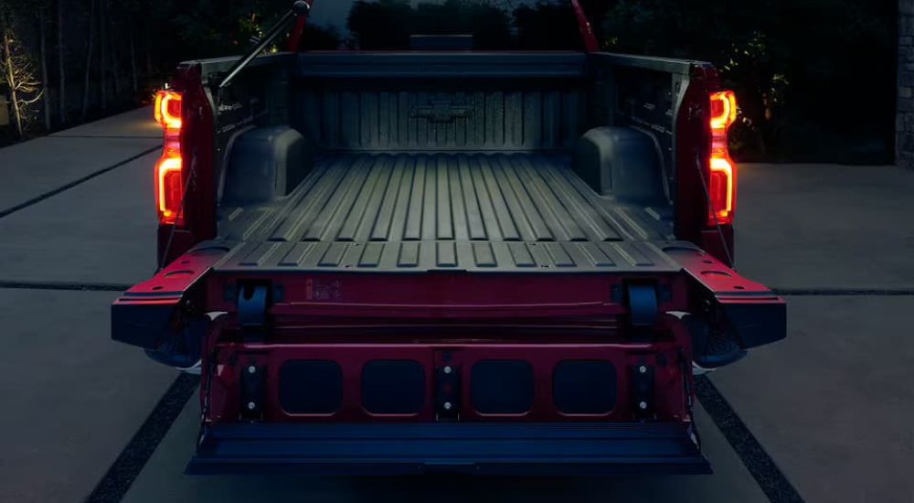 A close-up of a multiflex tailgate on a red 2024 Chevy Silverado 1500 is shown.