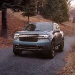 A blue 2024 Ford Maverick is shown driving on a trail.