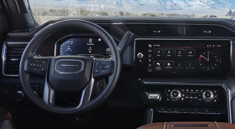 The black and brown interior and dash in a 2024 GMC Sierra 2500 HD is shown.