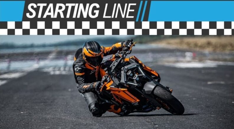 A Starting Line banner is shown over a person riding on an orange 2024 KTM Superduke 1390 evo.