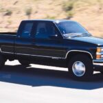A black 1999 Chevy Silverado 1500 Z71 is shown driving on a highway.