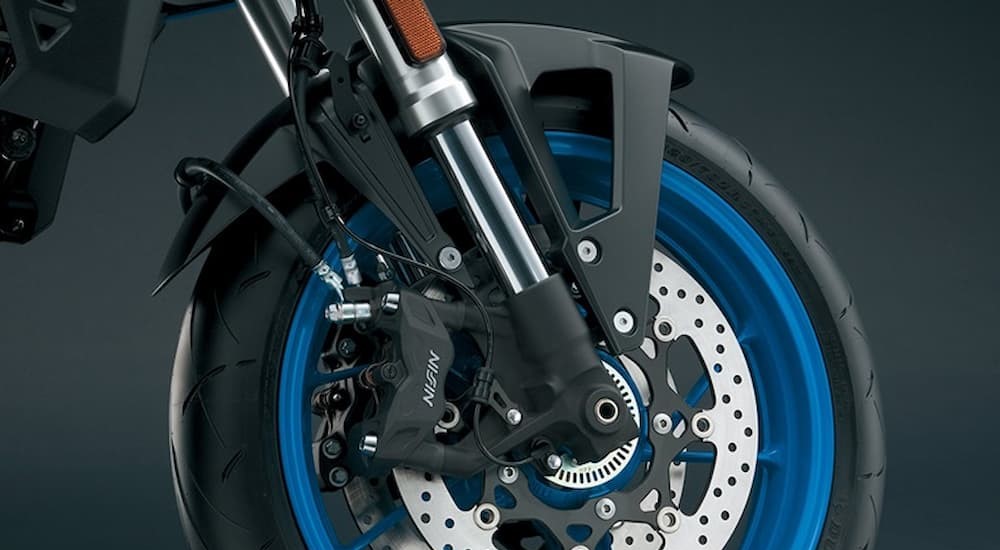 A close-up of the front for and wheel of a 2023 Suzuki GSX-8S is shown.