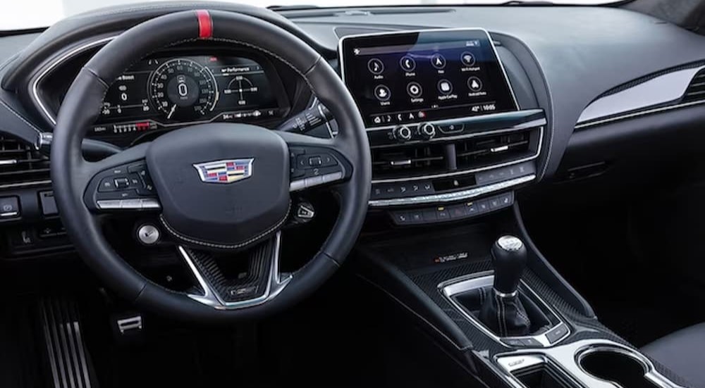 The black interior and dash of a 2024 Cadillac CT5 Blackwing is shown.