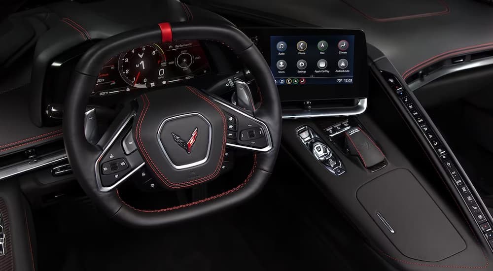 The black interior and dash of a 2024 Chevy Corvette Stingray is shown.