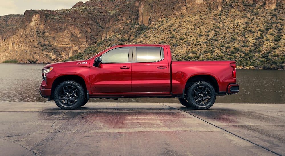 A red 2024 Chevy Silverado 1500 Z71 is shown parked from a side angle.
