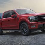 A red 2024 F-150 Lariat is shown parked off-road after winning the 2024 Ford F-150 vs 2024 RAM 1500 competition.