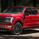 A red 2024 Ford F-150 is shown parked near a pond.