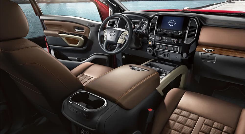 The brown and black interior and dash of a 2024 Nissan Titan PRO-4X is shown.