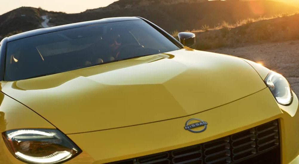 A close-up of the hood and headlights of a yellow 2024 Nissan Z is shown.