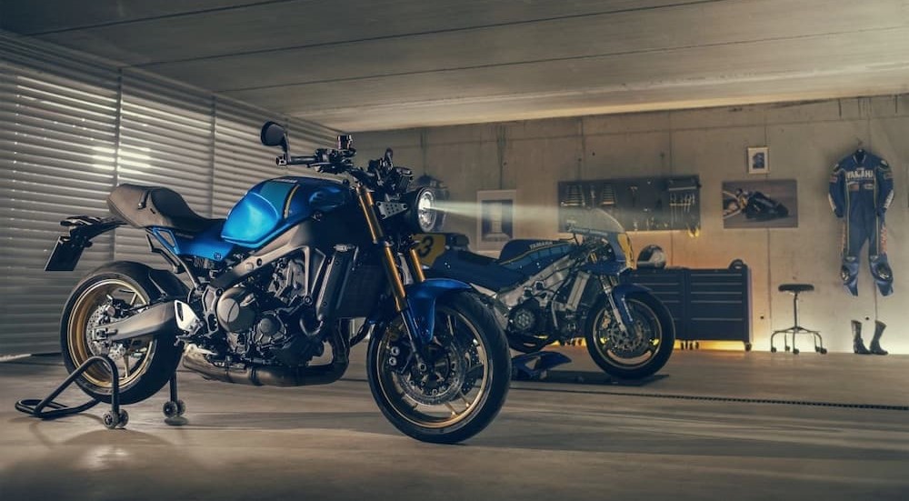 Parked near a Yamaha motorcycle dealer, a blue 2023 Yamaha XSR900, is shown parked in a garage.