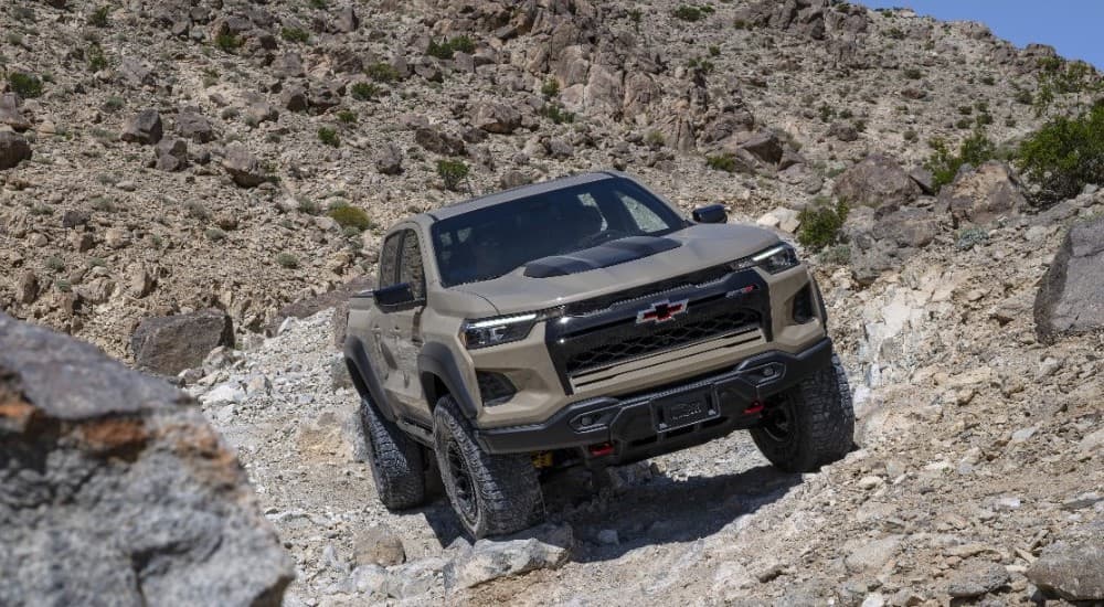 A brown 2024 Chevy Colorado ZR2 Bison is shown driving off-road.