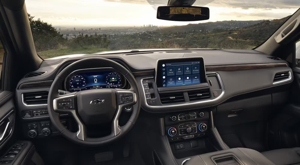 The black and gray interior and dash of a 2024 Chevy Tahoe is shown.