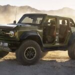 A green 2024 Ford Bronco Raptor is shown parked off-road.