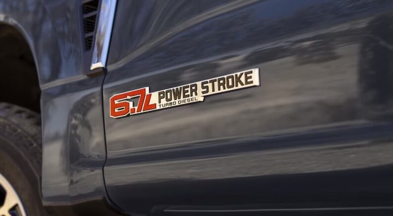 Closeup of the Power Stroke badge on a dark blue 2024 Ford F-250.