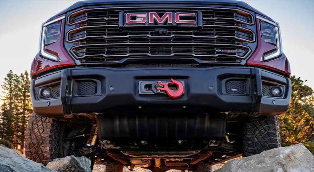 A close-up on the front skid plate of a red 2024 GMC Sierra 1500 AT4 is shown.