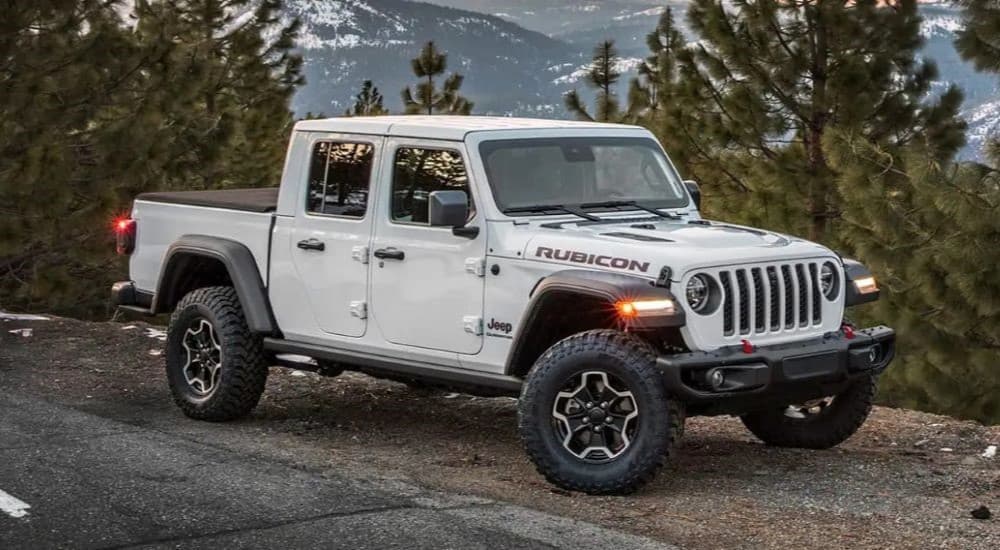 A white 2023 Jeep Gladiator Rubicon is shown parked after visiting a Jeep dealership.