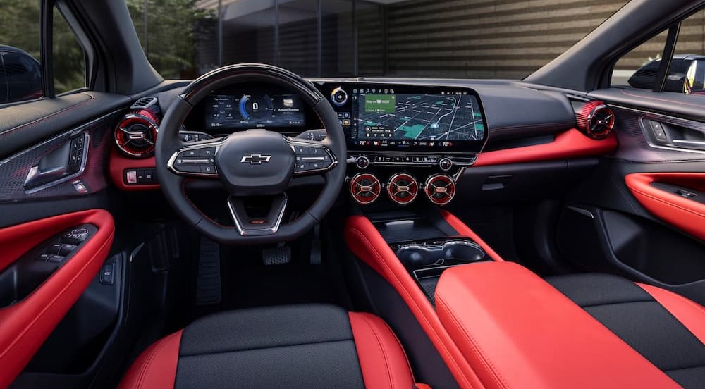 The black and red interior and dash of a 2024 Chevy Blazer EV is shown.