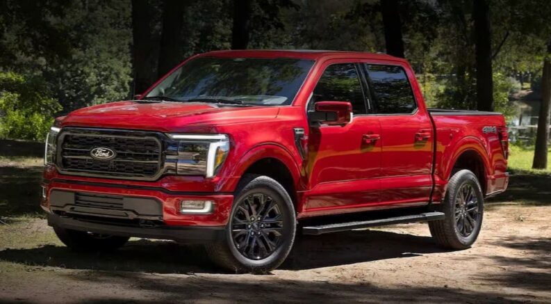 A red 2024 Ford F-150 for sale is shown parked off-road.