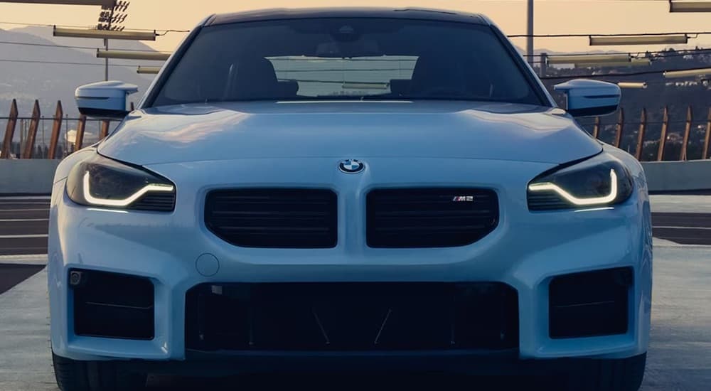 A blue 2023 BMW M2 Coupe is shown from a front angle.