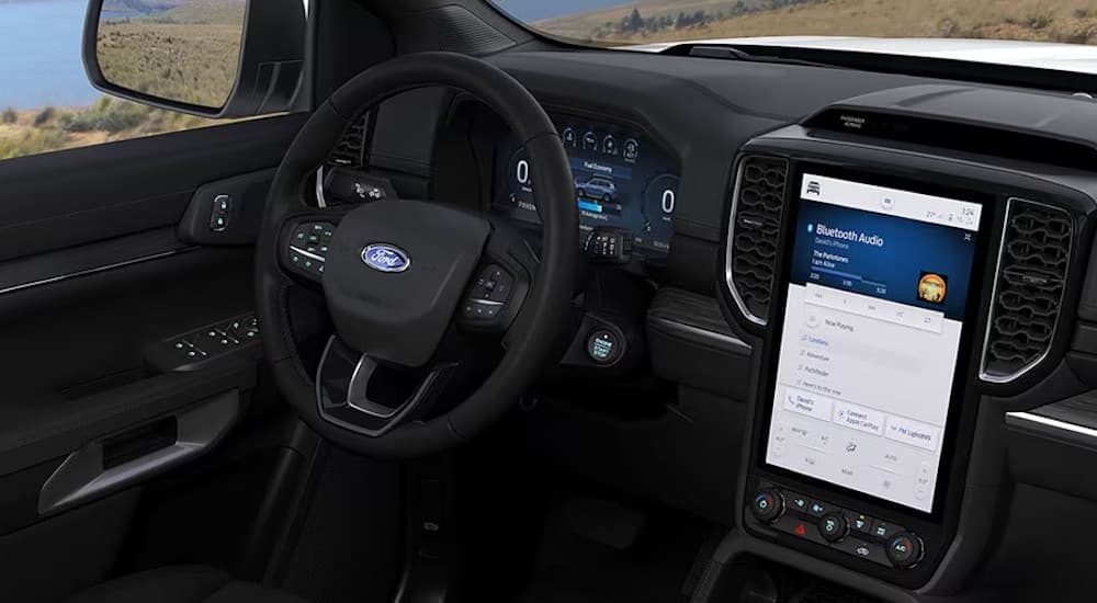 The black interior of a 2024 Ford Everest is shown from the driver's seat.