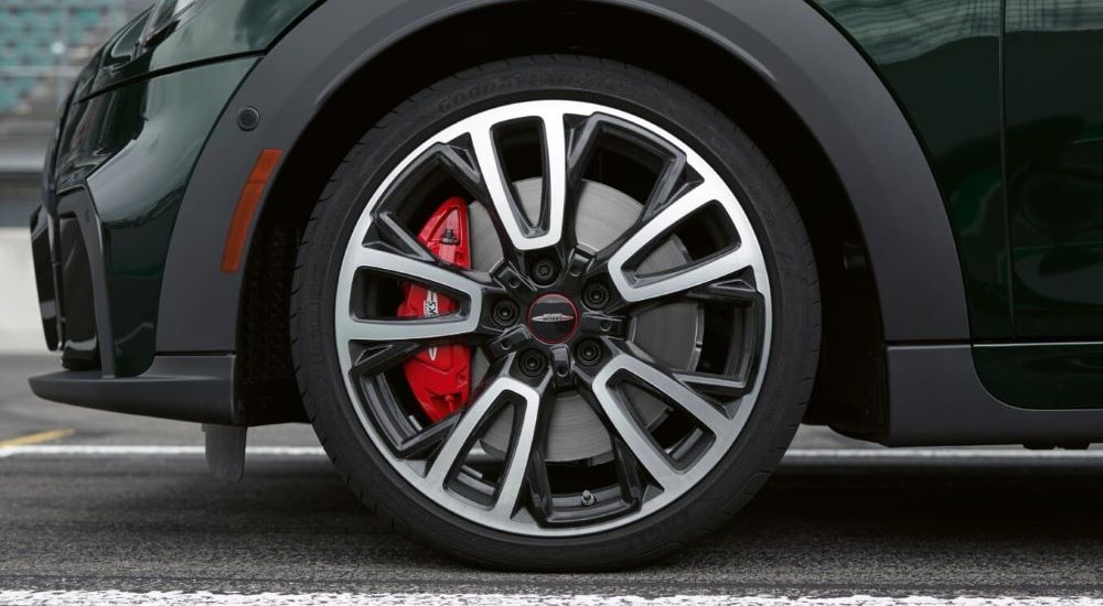 A close up shows the red caliper on a green 2024 MINI John Cooper Works.