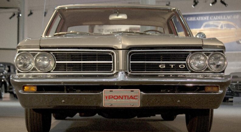 A silver 1964 Pontiac GTO is shown from a front angle.