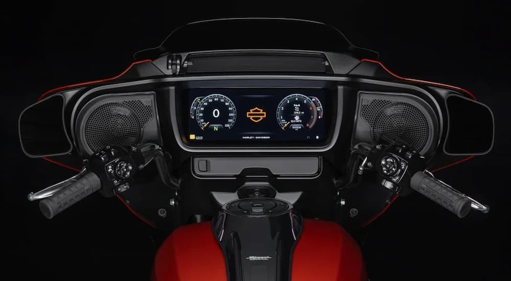 The close-up of a digital dash on an orange 2024 Harley-Davidson Street Glide is shown.