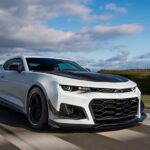 A white and black 2024 Chevy Camaro Z71 driving on a track.