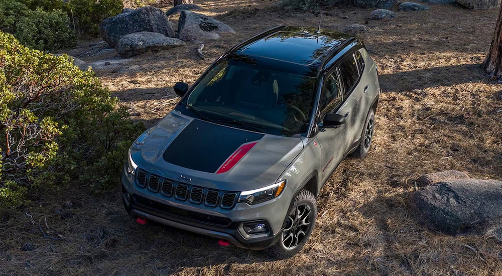 Overhead view of a grey 2024 Jeep Compass Trailhawk parked in the woods.