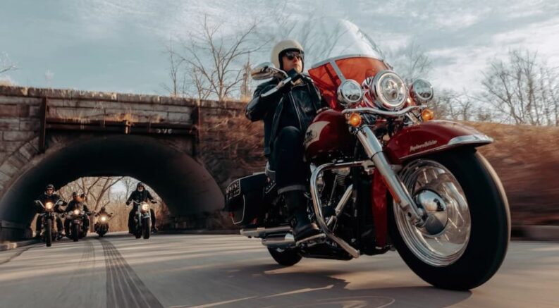 A person is shown riding a 2024 Harley-Davidson Hydra-Glide Revival after visiting a Harley-Davidson dealer.